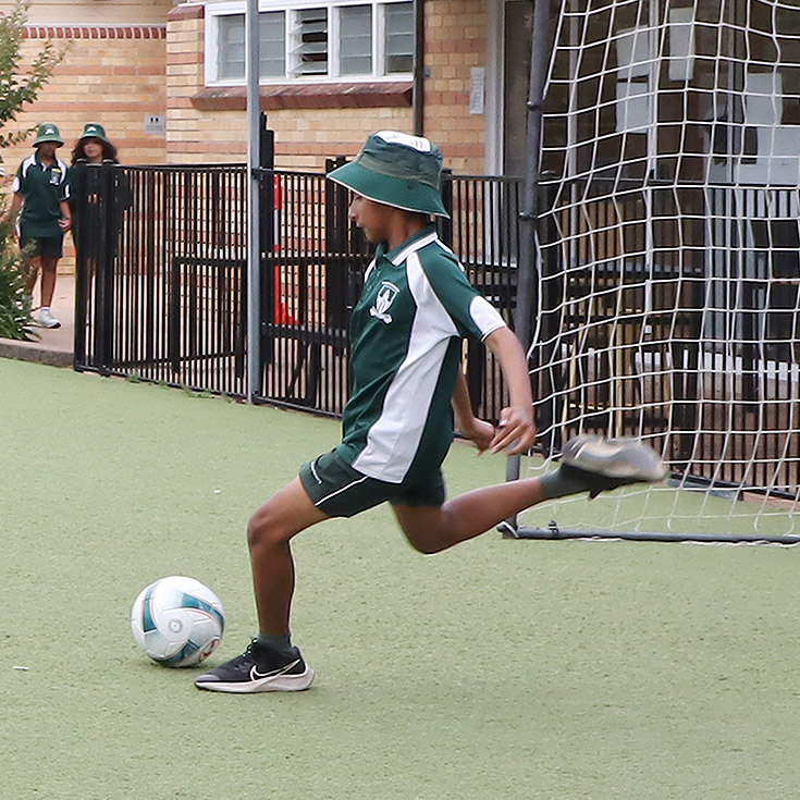 St Anthony's Catholic Primary School Girraween student playing soccer