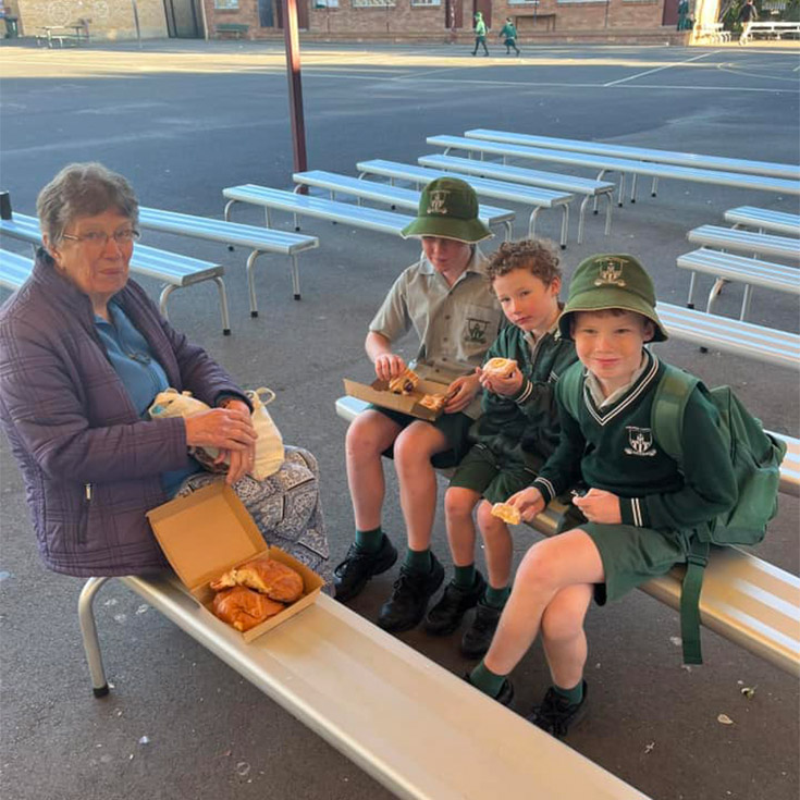 St Anthony's Catholic Primary School Girraween students and grandmother eating pastries